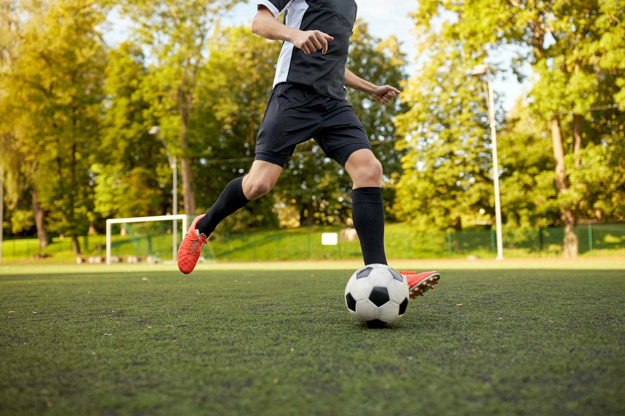 soccer player playing with ball on football field